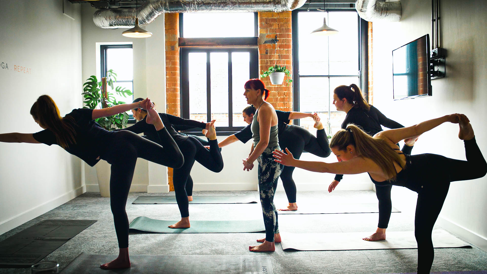 Photograph of Carolyn Collinson teaching a yoga class in the EMEA Recruitment office