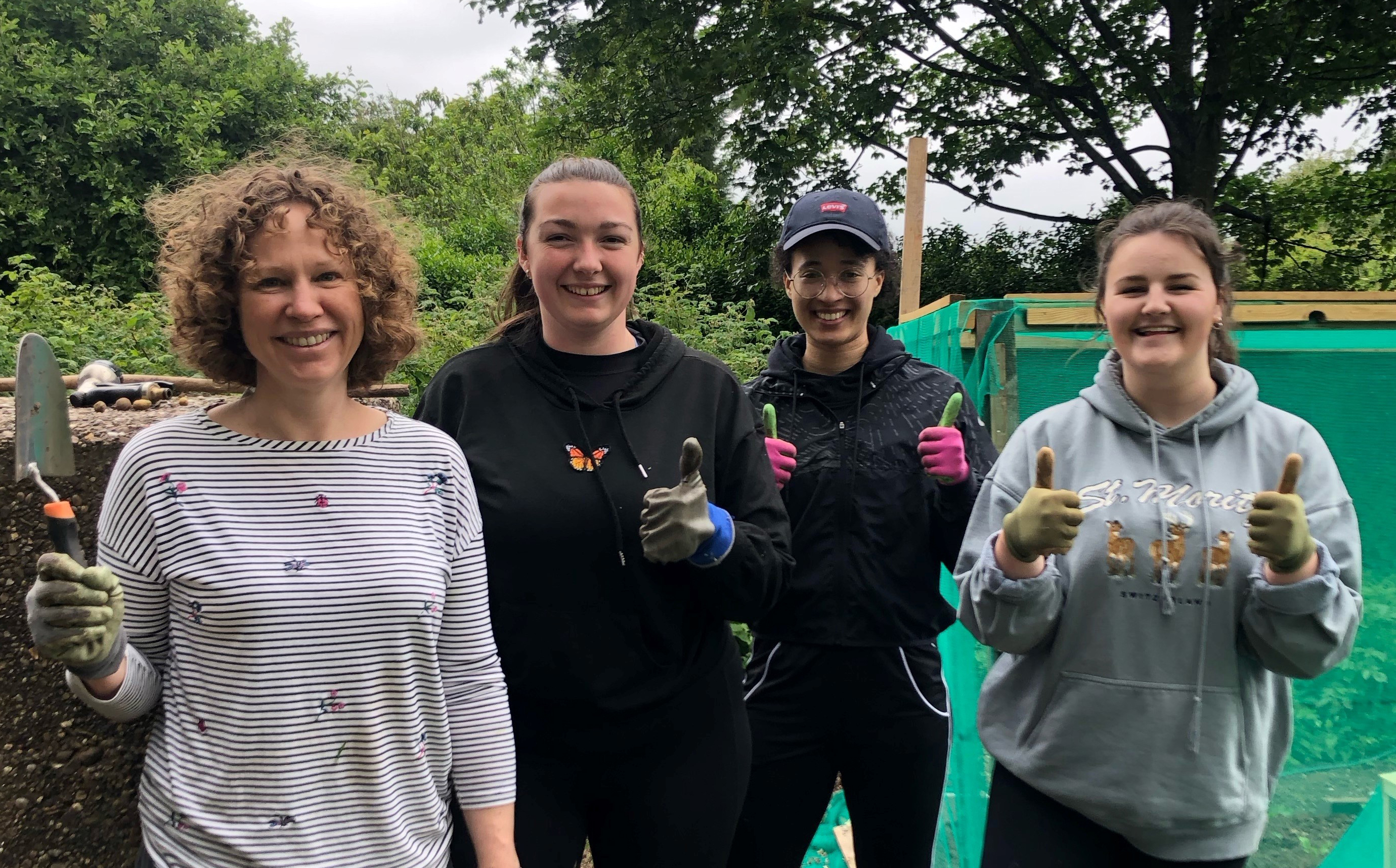 Photograph of Annie Gosnell, Sasha Gill, Tamika Gayle and Amy Black at the Trussell Trust allotment in Beeston, the UK