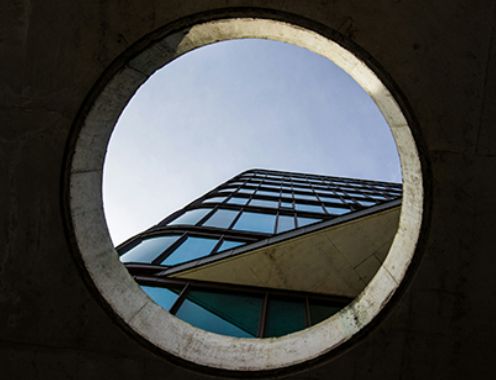 A photograph of a modern office block from a ground view