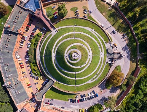 A bird's-eye photograph of a circular green hill in Poland